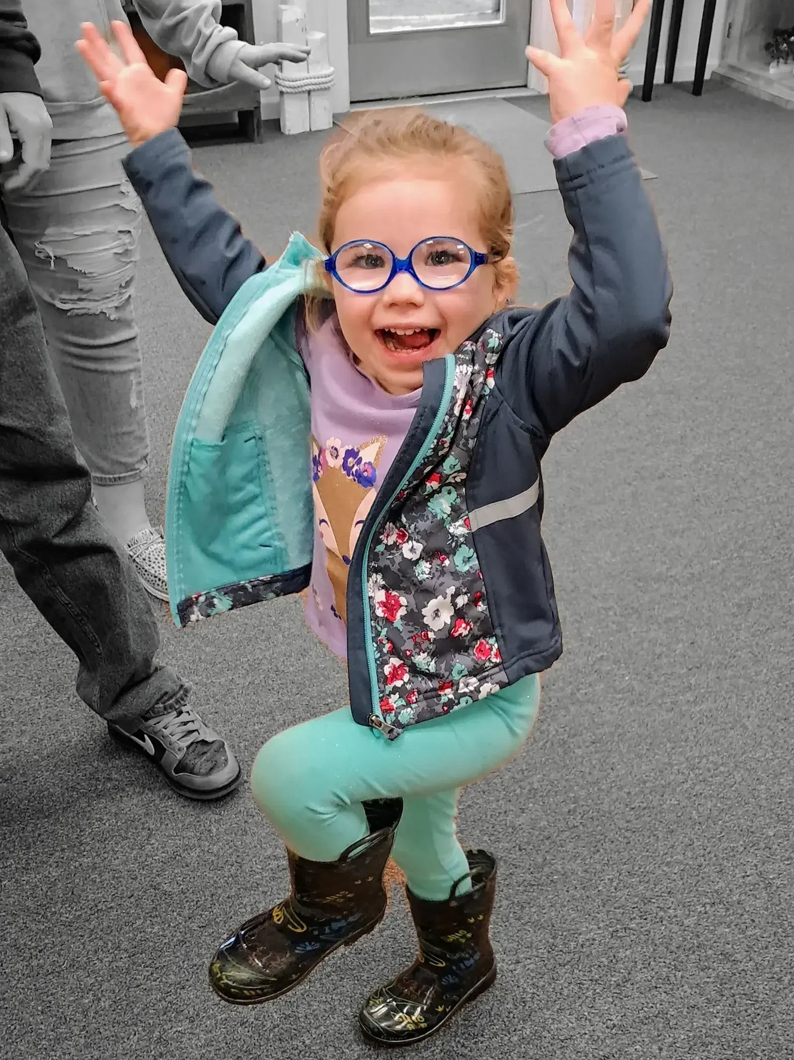 happy child dancing after getting her eye glasses