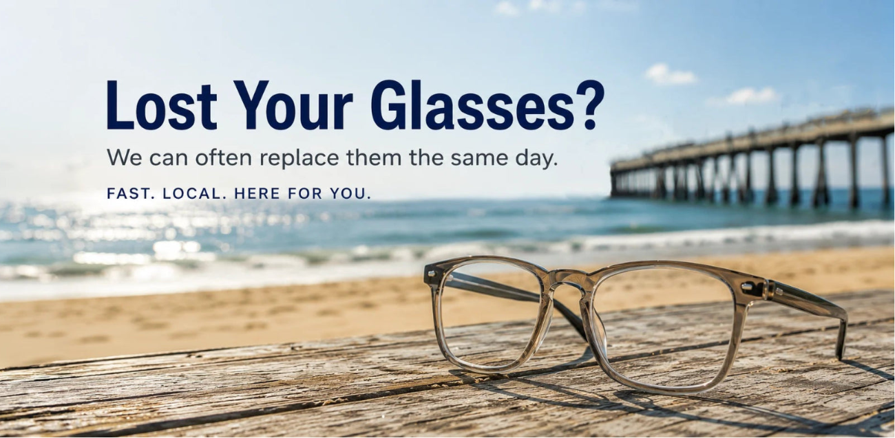 A pair of clear-lens eyeglasses with a thin gold-tone frame rests on a weathered wooden surface in front of a beach and pier background. Promotional text on the left reads, 'Lost Your Glasses? We can often replace them the same day.